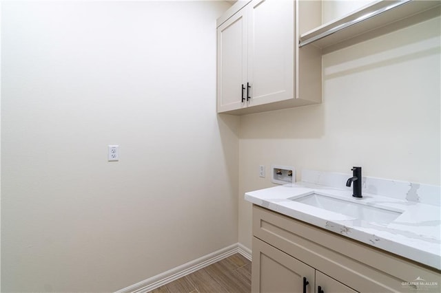 536 Pearl St, Edinburg, TX 78539 - laundry area featuring washer hookup, baseboards, cabinet space, and light wood-style floors