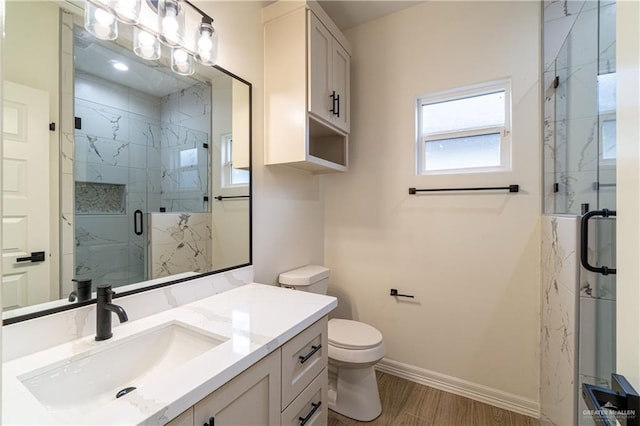 536 Pearl St, Edinburg, TX 78539 - bathroom with vanity, baseboards, a marble finish shower, toilet, and wood finished floors