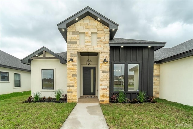 536 Pearl St, Edinburg, TX 78539 - contemporary home with board and batten siding, a front lawn, roof with shingles, and stone siding
