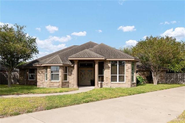 313 Royal St, Edinburg, TX 78539 - view of front facade featuring brick siding, a front lawn, and fence