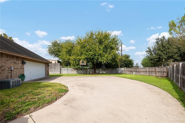 313 Royal St, Edinburg, TX 78539 - view of yard with central AC, concrete driveway, a fenced backyard, and a garage