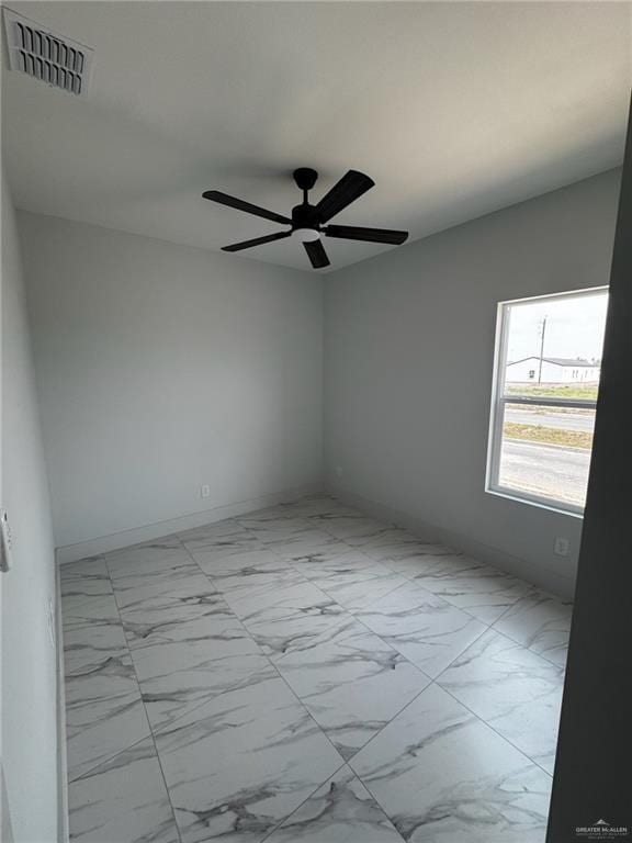2809 Alpha Rd, Weslaco, TX 78596 - empty room with marble finish floor, baseboards, visible vents, and ceiling fan