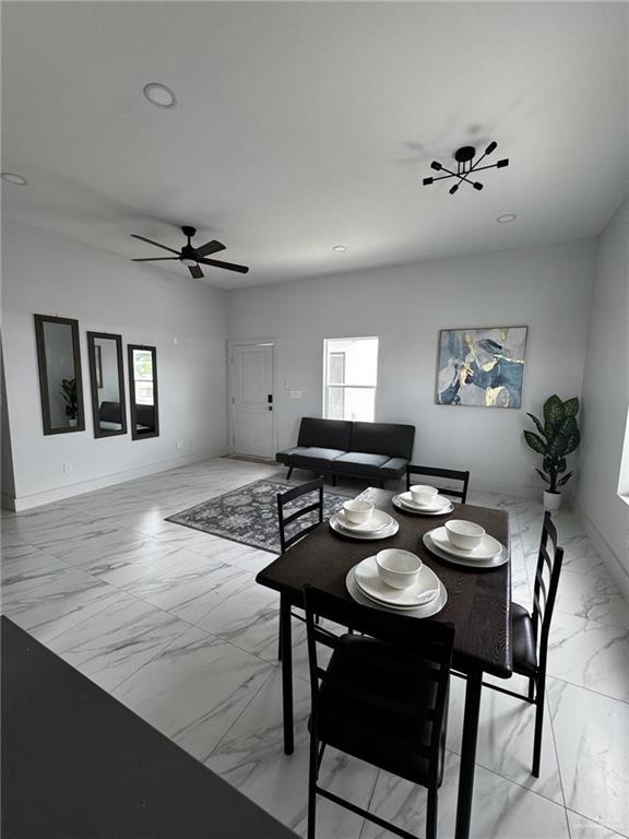 2809 Alpha Rd, Weslaco, TX 78596 - dining room with a ceiling fan, marble finish floor, and baseboards