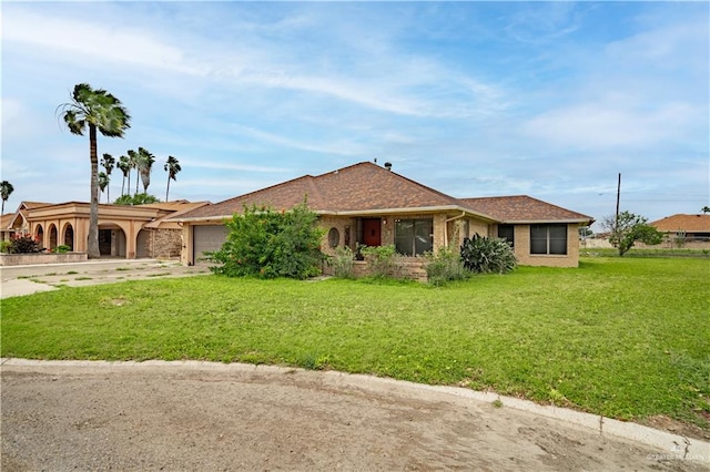 ranch-style home with a front yard and a garage