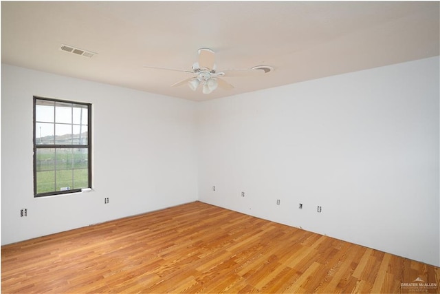 empty room featuring ceiling fan and light hardwood / wood-style flooring