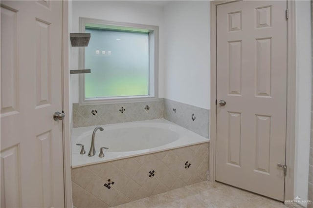 bathroom featuring a bath and tile patterned flooring