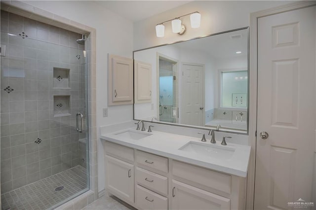bathroom with a shower stall, double vanity, and a bathtub
