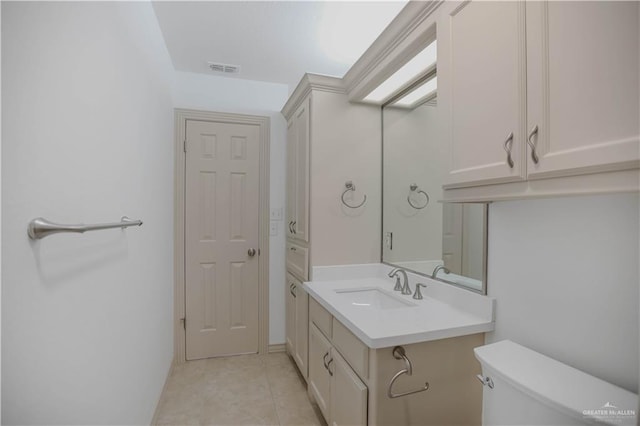 bathroom featuring toilet, vanity, and tile patterned flooring