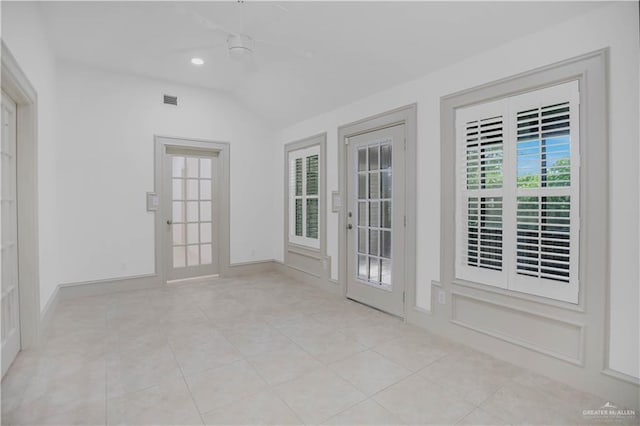 empty room with vaulted ceiling, tile patterned flooring, baseboards, and recessed lighting