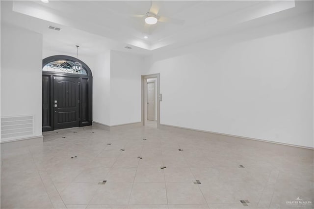 unfurnished room featuring ceiling fan, recessed lighting, baseboards, and a tray ceiling