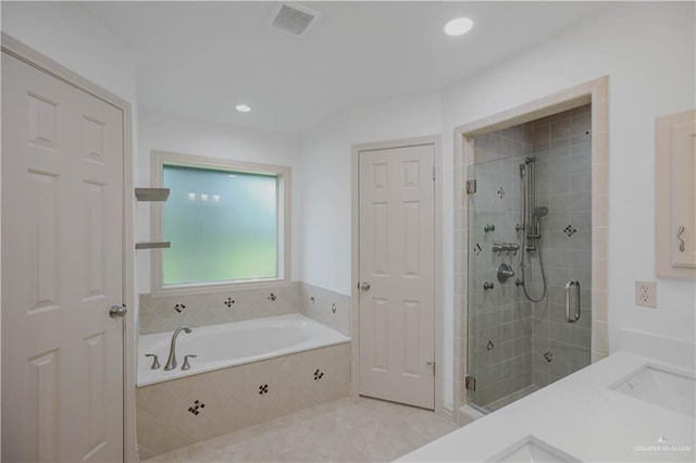 full bath featuring a shower stall, a garden tub, a sink, and recessed lighting