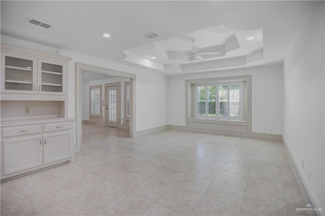 spare room with a tray ceiling, a ceiling fan, french doors, recessed lighting, and baseboards