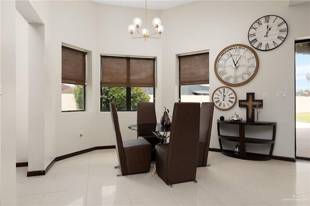 dining room with light tile patterned floors and a notable chandelier