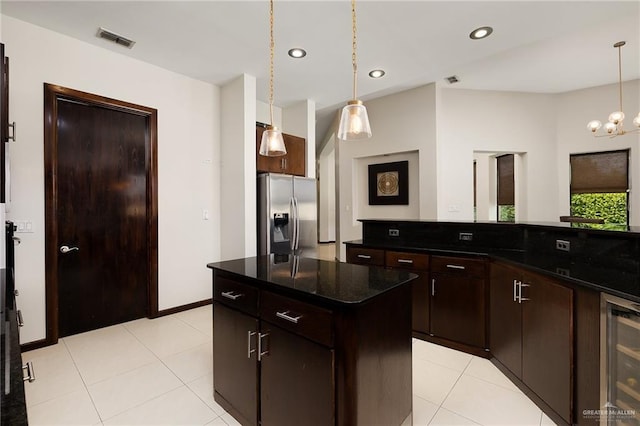 kitchen featuring pendant lighting, stainless steel refrigerator with ice dispenser, wine cooler, dark brown cabinetry, and a kitchen island