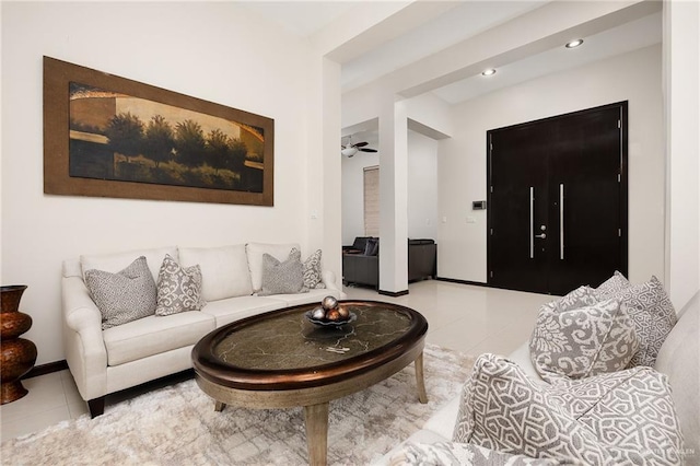 tiled living room with ceiling fan