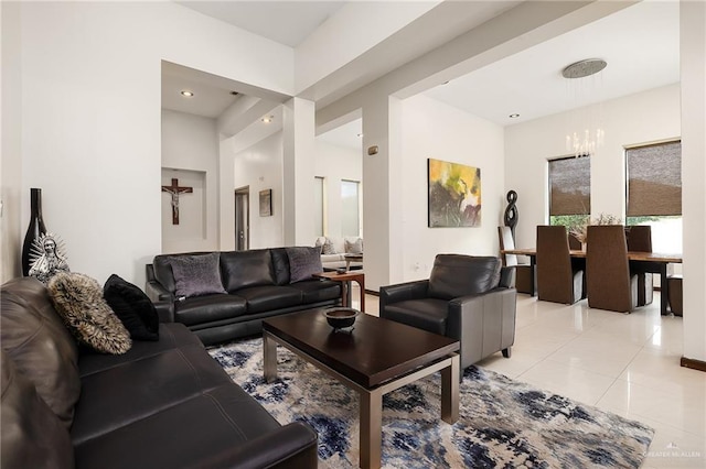 living room with a chandelier and light tile patterned floors