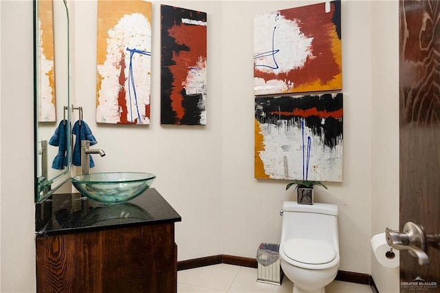 bathroom featuring vanity, tile patterned floors, and toilet