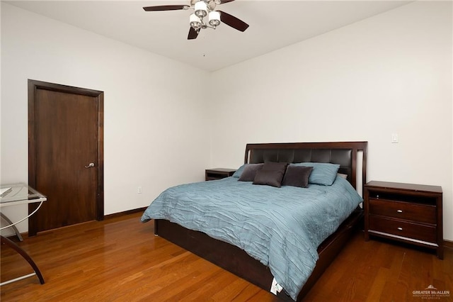 bedroom with dark wood-type flooring and ceiling fan