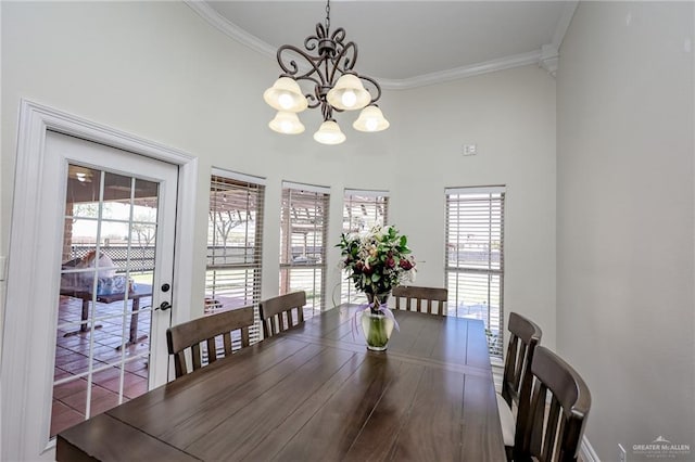 dining room with ornamental molding, a wealth of natural light, and a notable chandelier