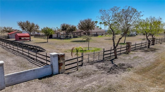 view of yard with fence and a rural view