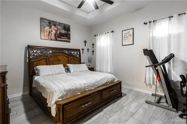 bedroom with ceiling fan and multiple windows