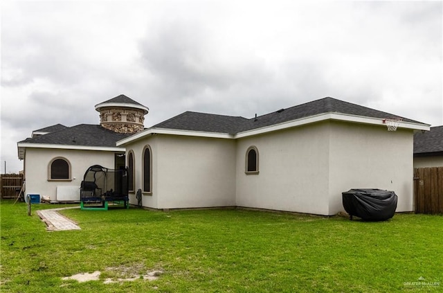 back of house featuring a yard