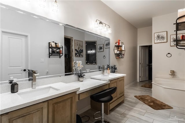 bathroom featuring vanity and a tub