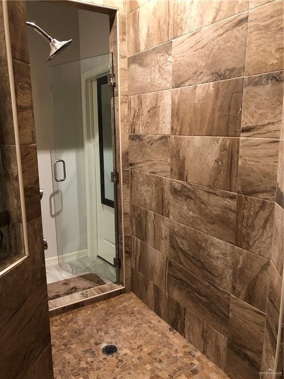 bathroom with tiled shower