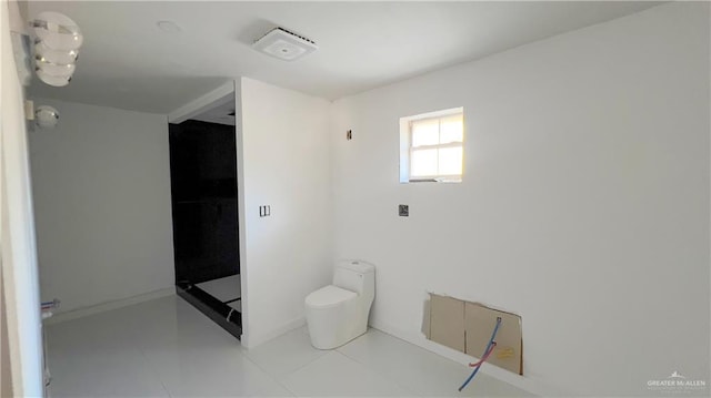 bathroom with tile patterned floors and toilet