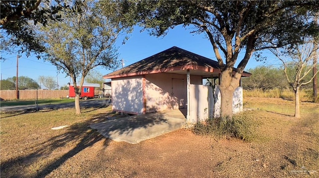 view of home's exterior with a storage unit