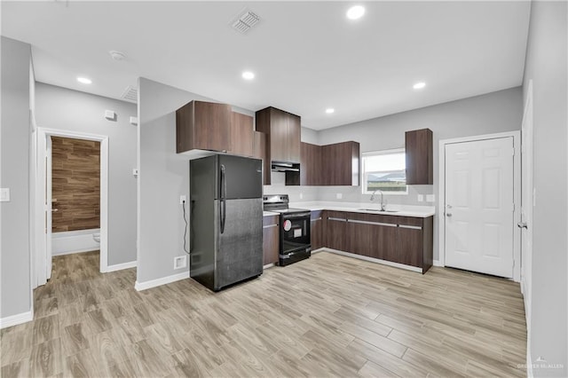 kitchen featuring dark brown cabinetry, sink, black appliances, and light hardwood / wood-style flooring