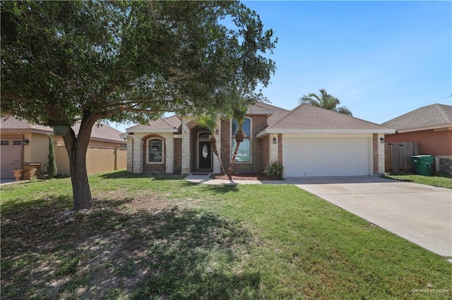 5212 N Huisache St, Pharr, TX 78577 - view of front facade featuring a garage, fence, a front yard, and concrete driveway