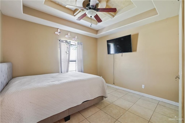 5212 N Huisache St, Pharr, TX 78577 - bedroom with light tile patterned floors, baseboards, ceiling fan, and a tray ceiling