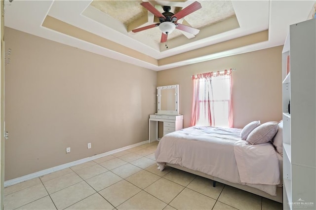5212 N Huisache St, Pharr, TX 78577 - bedroom featuring baseboards, light tile patterned floors, and a raised ceiling