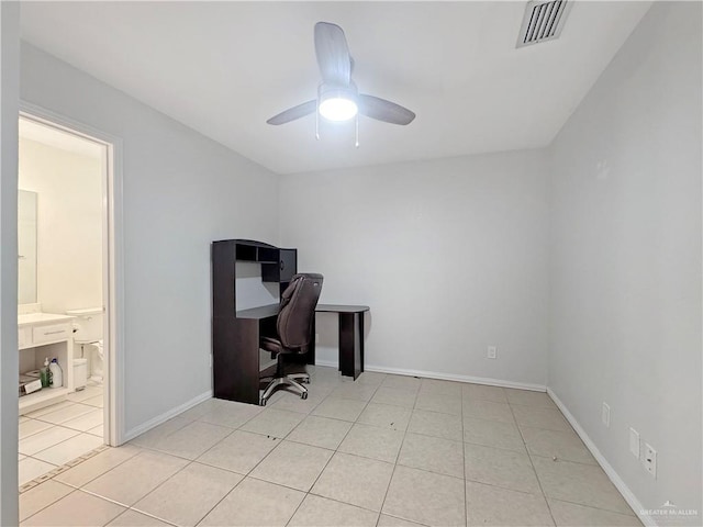 office space with a ceiling fan, baseboards, visible vents, and light tile patterned floors
