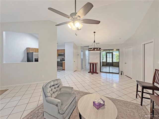 living area with baseboards, a ceiling fan, light tile patterned floors, and vaulted ceiling