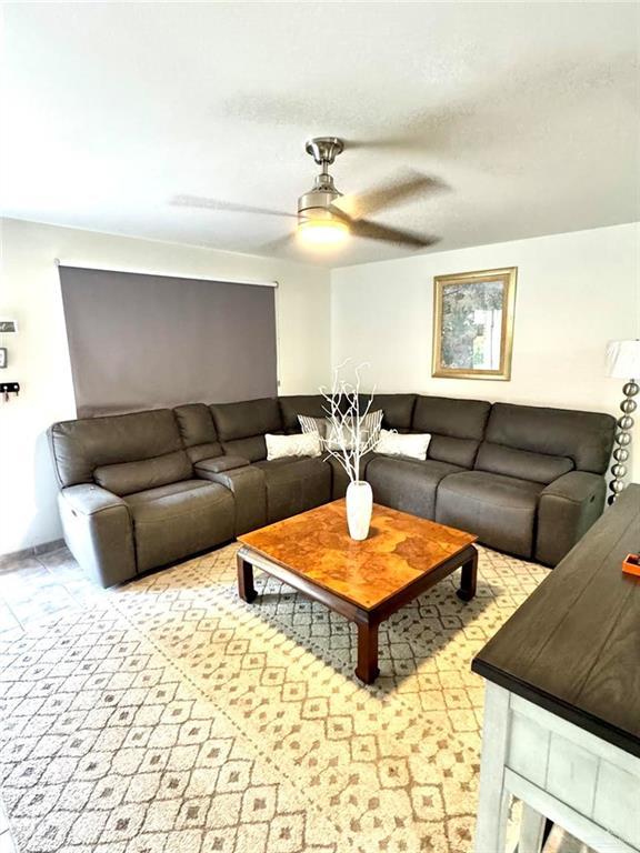 living room with a ceiling fan