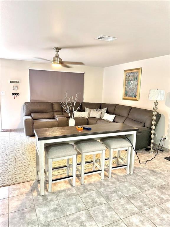 living room with visible vents and ceiling fan