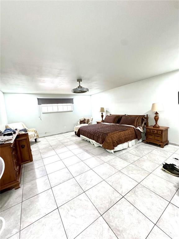 bedroom with light tile patterned floors