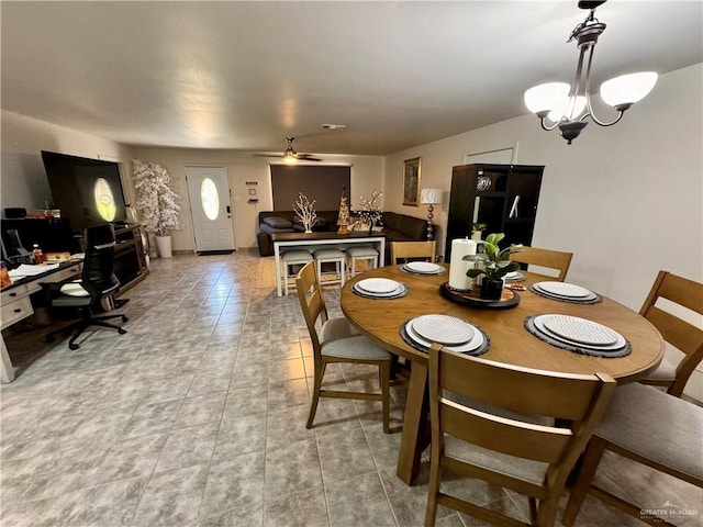 dining area with light tile patterned flooring and a ceiling fan