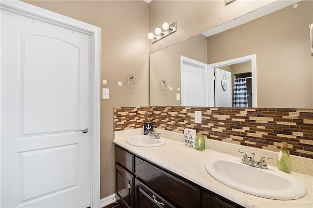 bathroom featuring tasteful backsplash and vanity