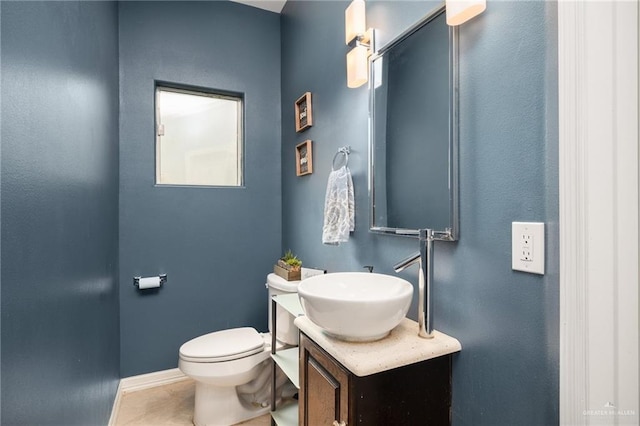 bathroom featuring tile patterned floors, vanity, and toilet