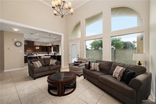 tiled living room with a towering ceiling, crown molding, and an inviting chandelier