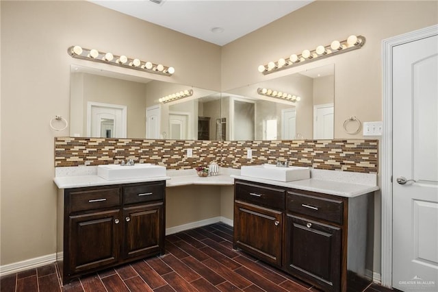 597 Greystone Cir, Alamo, TX 78516 - bathroom featuring vanity, tasteful backsplash, and wood finished floors