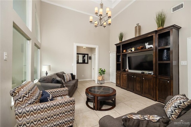 living room featuring light tile patterned flooring, ornamental molding, a high ceiling, and an inviting chandelier