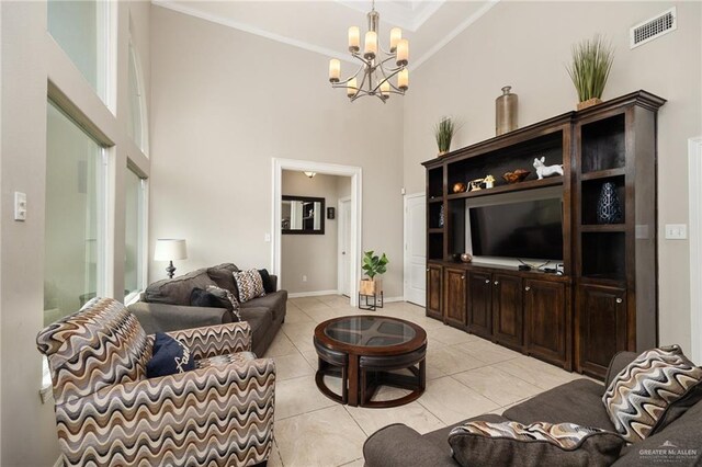 597 Greystone Cir, Alamo, TX 78516 - living room with ornamental molding, a chandelier, a towering ceiling, and light tile patterned floors