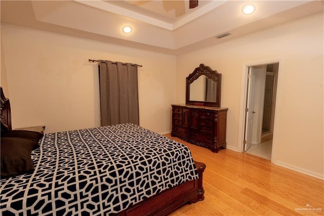 907 Amethyst Dr, Weslaco, TX 78596 - bedroom with light wood-type flooring, recessed lighting, a tray ceiling, and ceiling fan