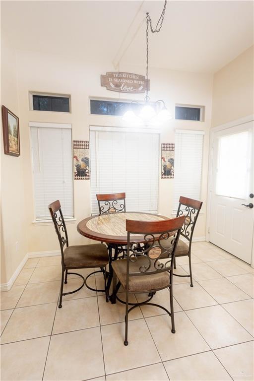907 Amethyst Dr, Weslaco, TX 78596 - dining room with light tile patterned floors and baseboards