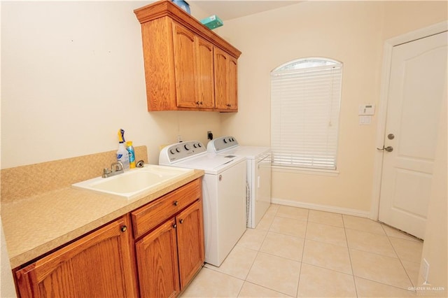 907 Amethyst Dr, Weslaco, TX 78596 - laundry area featuring cabinet space, washer and dryer, and light tile patterned flooring