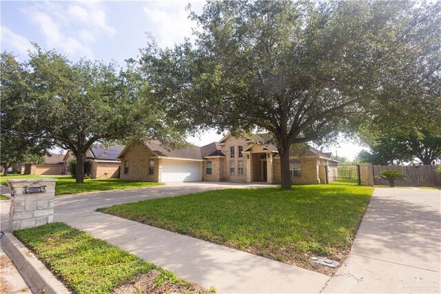 907 Amethyst Dr, Weslaco, TX 78596 - view of front of house featuring asphalt driveway, a garage, and brick siding